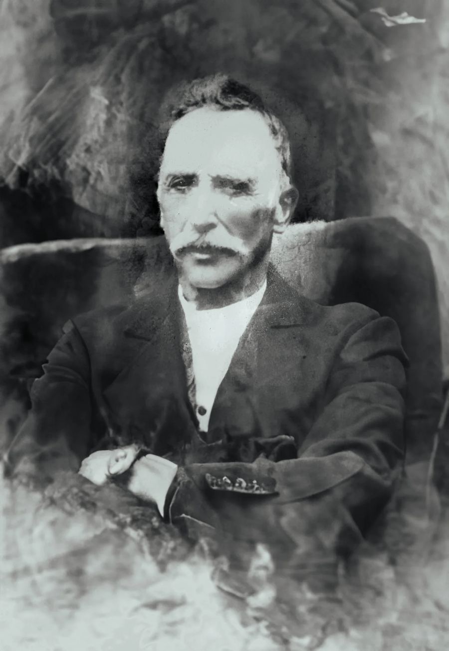Historic portrait of Amaral, seated, in a dark jacket